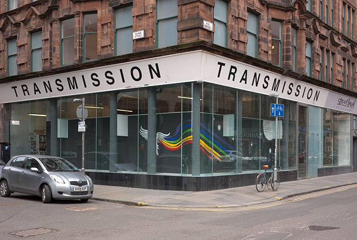 documentation photo of a window mural of a white phoenix in outer space with a rainbow trail from its left wing